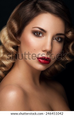 Amazing facial portrait of beauty  girl with brown eyes, dark brown eye-shadows and deep red lipstick, with ambre effect and curls hair  on dark background