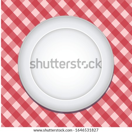 Isolated blank plate in red gridded tablecloth