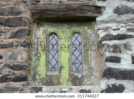 Saxon Sandstone Window in Culbone Church , Said to be the Smallest Church in England, (St Bueno) on the South West Coastal Path in Exmoor National Park on the North Coast of Somerset, England, UK