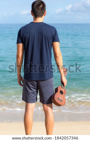 Similar – Image, Stock Photo Pensive man playing ukulele guitar