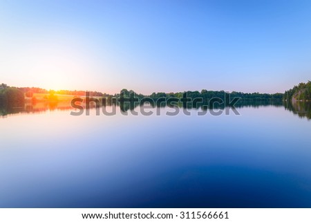 Lake evening sunset reflected in water Finland and the Aland Islands