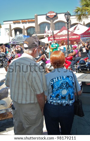 DAYTONA BEACH, FL - MARCH 17:  Spectators of all ages watch the bikers cruise Main Street during \