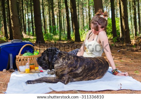 Girl on picnic with her dog.