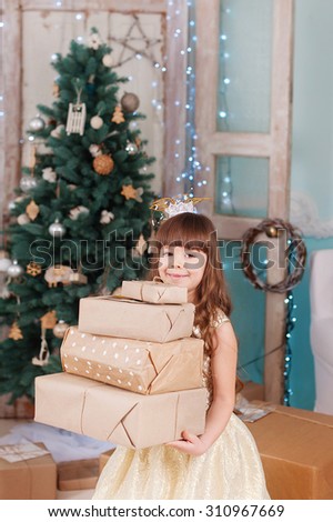 the girl in the new year holds a lot of gifts
