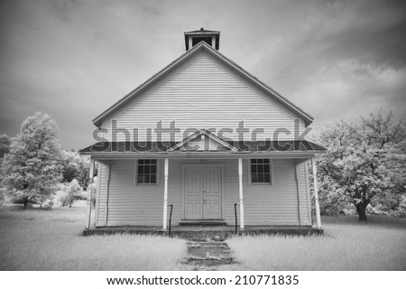 A black and white infrared image of a historic one room school house.