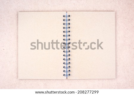 Recycled paper notebook cover on wood background