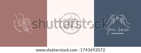 Linear logo of the photographer. Women's Hands hold the camera shutter. Abstract symbol for a photo Studio in a simple minimalistic style. Vector logo template for wedding photographer 商業照片 © 