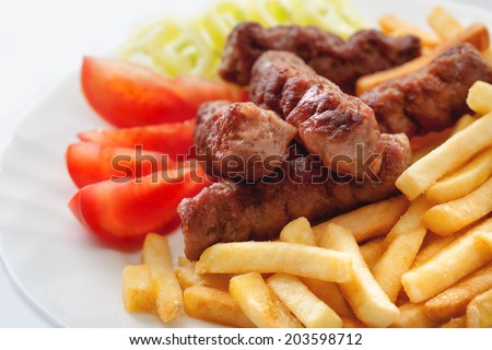 Kebab, turkish / balkanish traditional meal, barbecued meat with french fries / fried potato