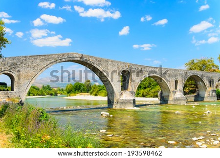 The Bridge of Arta is an old stone bridge that crosses the Arachthos river in the west of the city of Arta in Greece.