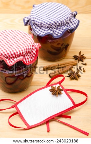 Fruit compote in the glass jar on the wooden background