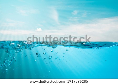 Spectacular ocean waves stop steaming with separate bubbles on a bright sky background. Popular corners, natural concepts