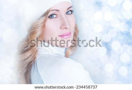 Winter Beauty Woman.Snow Queen. Portrait over Blue Snow Background. Beauty Fashion Model Girl with White Hair and Blue Eyes closeup.
