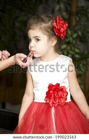 Little girl doing makeup before dance competitions
