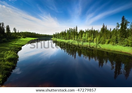 The river with a quiet current and clouds reflected in it, Sakha (Yakutia) Republic, Eastern Siberia, Russia