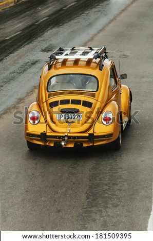 VARADERO, CUBA - NOVEMBER 28, 2013: Gold Volkswagen Beetle vintage car at the city street.