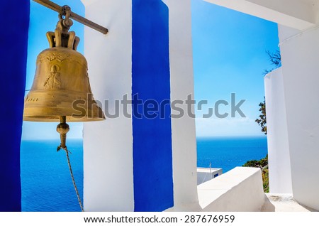 Iconic view on golden bell and typical blue-white church on Greek Island Kalymnos, Greece