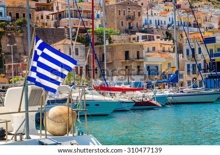Blue white Greek flag and wind in Greek port full of boats, Kos, Greece