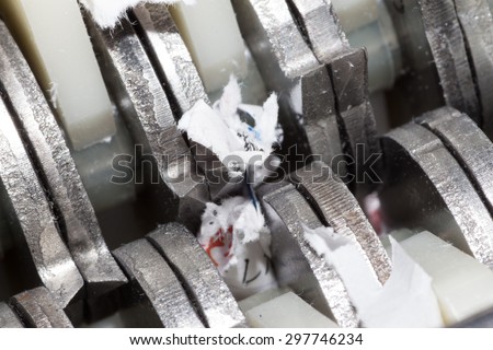Jammed shredder scraps between paper shredder blades