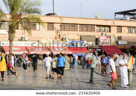 MARRAKESH, MOROCCO - AUGUST 24: Tourists visiting Djemaa el Fna - market place in Marrakesh\'s medina quarter on 24 August 2014 in Marrakesh, Morocco. Djemaa el Fna is a UNESCO world heritage site.