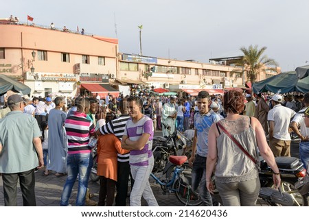 MARRAKESH, MOROCCO - AUGUST 24: Tourists visiting Djemaa el Fna - market place in Marrakesh\'s medina quarter on 24 August 2014 in Marrakesh, Morocco. Djemaa el Fna is a UNESCO world heritage site.