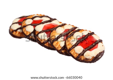 Sweet and crunchy biscuits cookies with jelly and striped chocolate on top isolated on white
