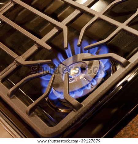 A blue flame from a gas cooktop burner