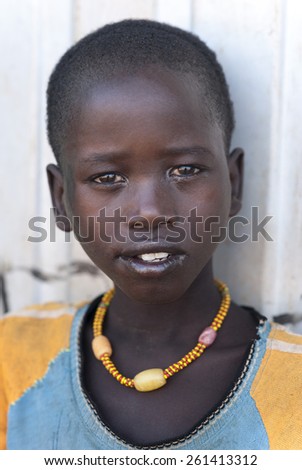Ethiopia-Africa-January first, 2013\
Unidentified young Ethiopian girl stading portrait in the streets in Omo Rift Valley, Ethiopia, Africa