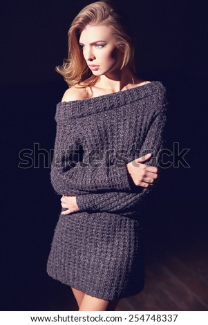 Portrait of beautiful woman in knitted dress. Fashion photo. Blonde girl