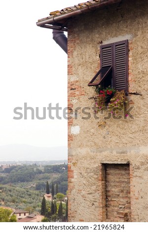 Obsolete Italian house with typical Italian landscape in background