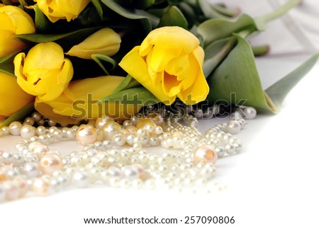 yellow tulips tied up with a ribbon isolated on white background, yellow tulips , pearls