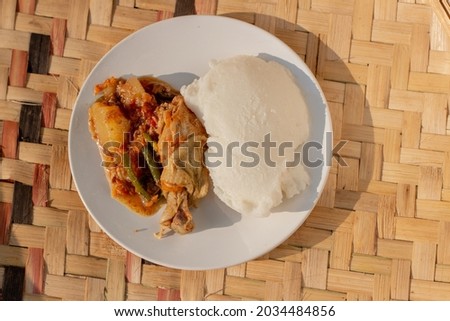A plate containing traditional African corn meal pap staple food and chicken stew Foto stock © 