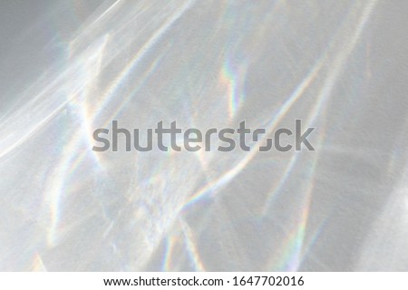Water texture overlay effect for photo and mockups. Organic drop diagonal shadow caustic effect with rainbow refraction of light on a white wall. 商業照片 © 