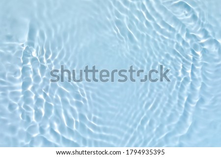 Blurred transparent blue colored clear calm water surface texture with splashes and bubbles. Trendy abstract nature background. Water waves in sunlight. ストックフォト © 