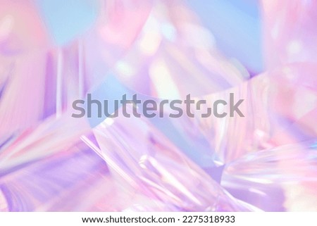 Close-up of ethereal pastel neon pink, purple, lavender, mint holographic metallic foil background. Abstract modern curved blurred surreal futuristic disco, rave, techno, festive dreamlike backdrop Foto stock © 
