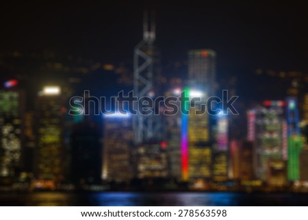 Blur background with illuminated buildings of skyscrapers at night time