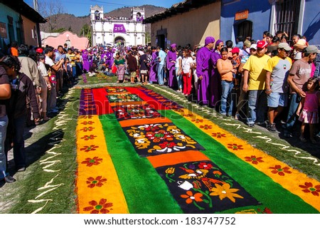 ANTIGUA, GUATEMALA - MARCH 25, 2007: Holy Week carpet (or alfombra) made in the path of a religious procession using wooden or cardboard stencils and dyed sawdust. In front of Santa Lucia church.