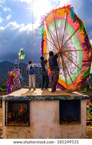 ALL SAINTS\' DAY, SANTIAGO SACATEPEQUEZ, GUATEMALA - NOVEMBER 1, 2010:  Locals fly and display huge kites or barriletes each year in the cemetery on All Saint\'s Day to honor the spirits of the dead
