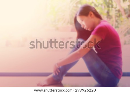 Blurred background : Sad woman with vintage filter