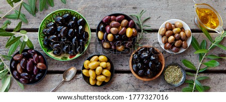 Similar – Image, Stock Photo Olives. A variety of green, black and red olives, with leaves, shot from the top with a place for text