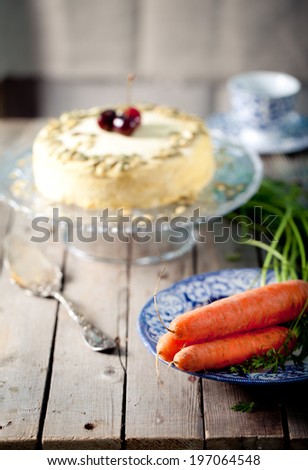 Carrot vegan cake with fresh carrots on a wooden table. Selective focus