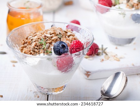 Healthy breakfast. Maple syrup glazes oat granola with pumpkin seeds, fresh berries and yogurt.