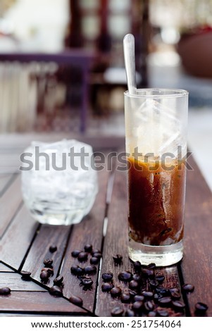 Traditional Vietnamese, Thai Ice coffee with coffee beans on a wooden background