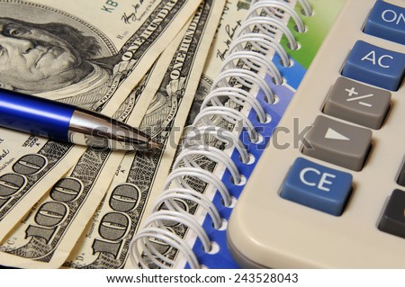 Business still-life with objects of business. Dollars and calculator
