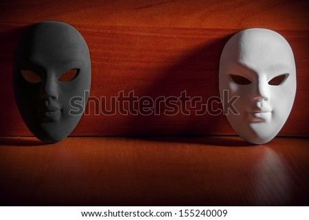 Black and white carnival mask on a wooden background with the space.