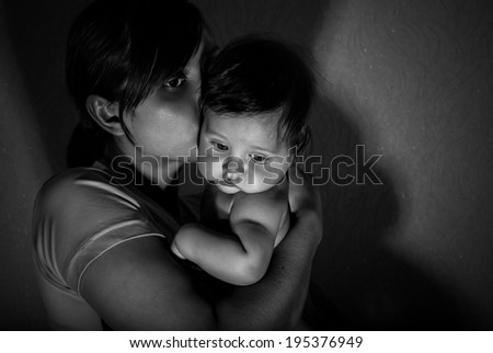 Black and white portrait of happy mother with baby.