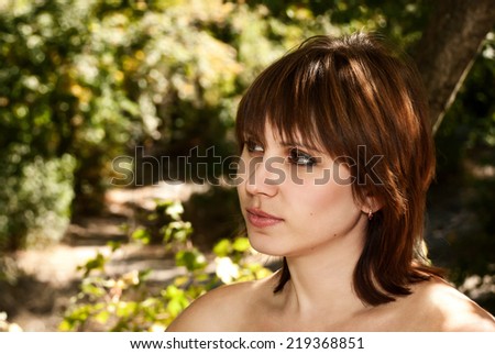 Face of beautiful woman outdoors with the effect of sunlight.
