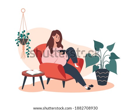 Woman sitting and resting on an armchair with coffee, rest at home Foto stock © 