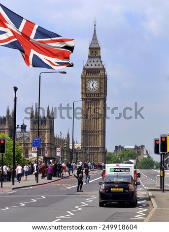 LONDON - MAY 15: Big Ben and the main street with English flag in London on May 15.2015 in England.