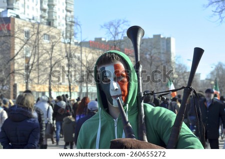 MOSCOW - MAR 14: Guy-bagpiper  during St Patrick\'s day party with Irish flag on the face in Moscow on March 14. 2015 in Russia