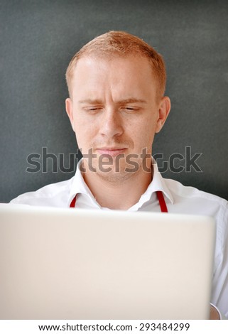 Young guy at the work with a laptop